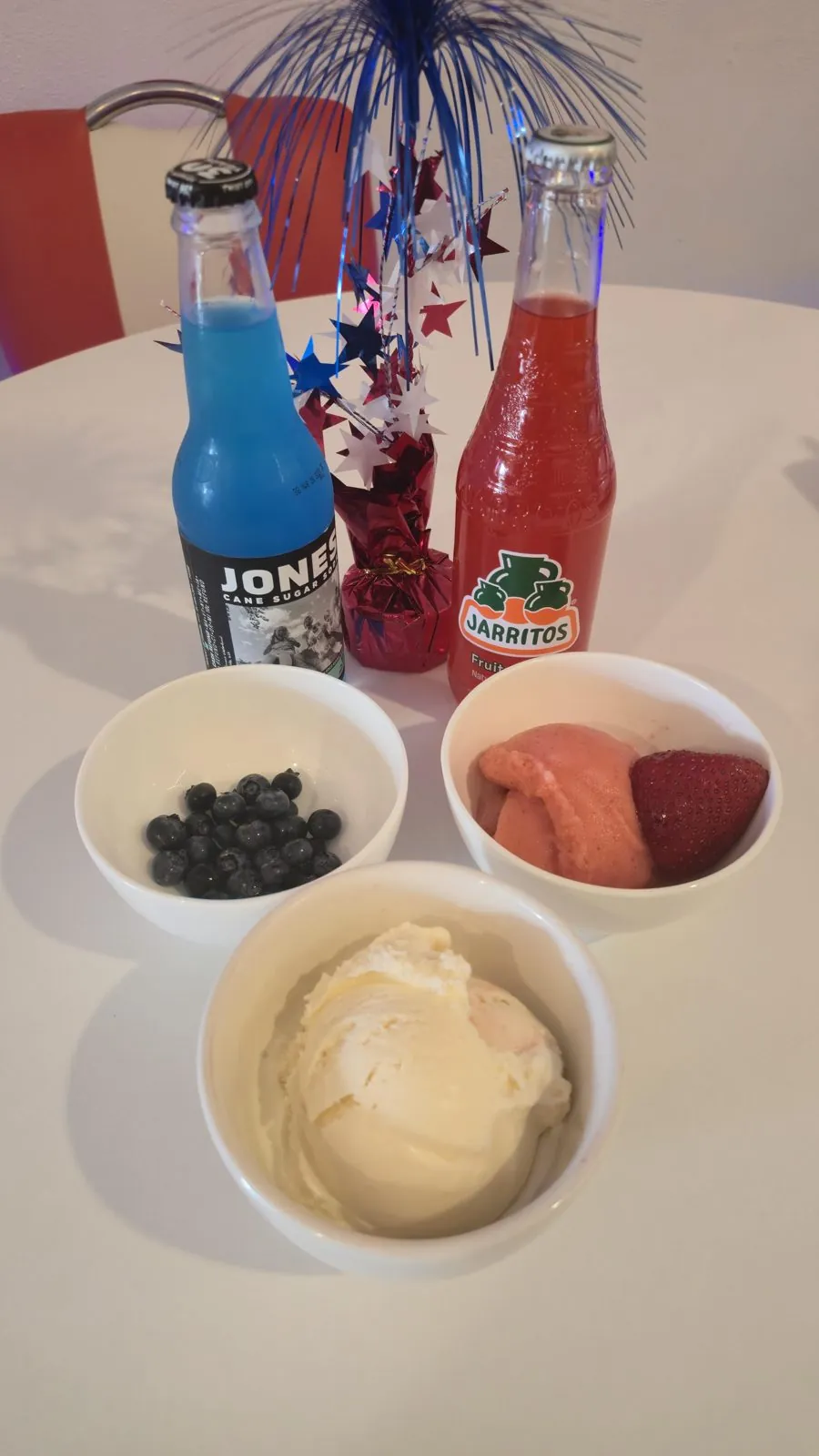 4th of July treat prep — blueberries, strawberries, vanilla ice cream, and red and blue cane sugar sodas