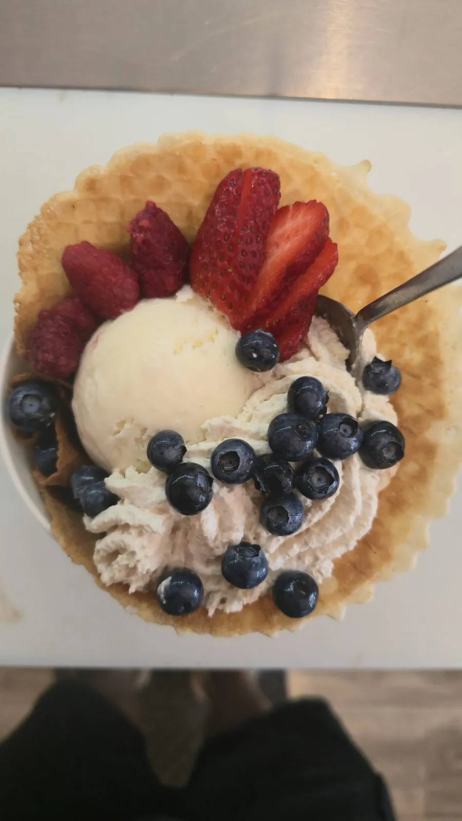 Freedom Sundae — vanilla ice cream in a waffle bowl with whipped cream, strawberries, raspberries, and blueberries