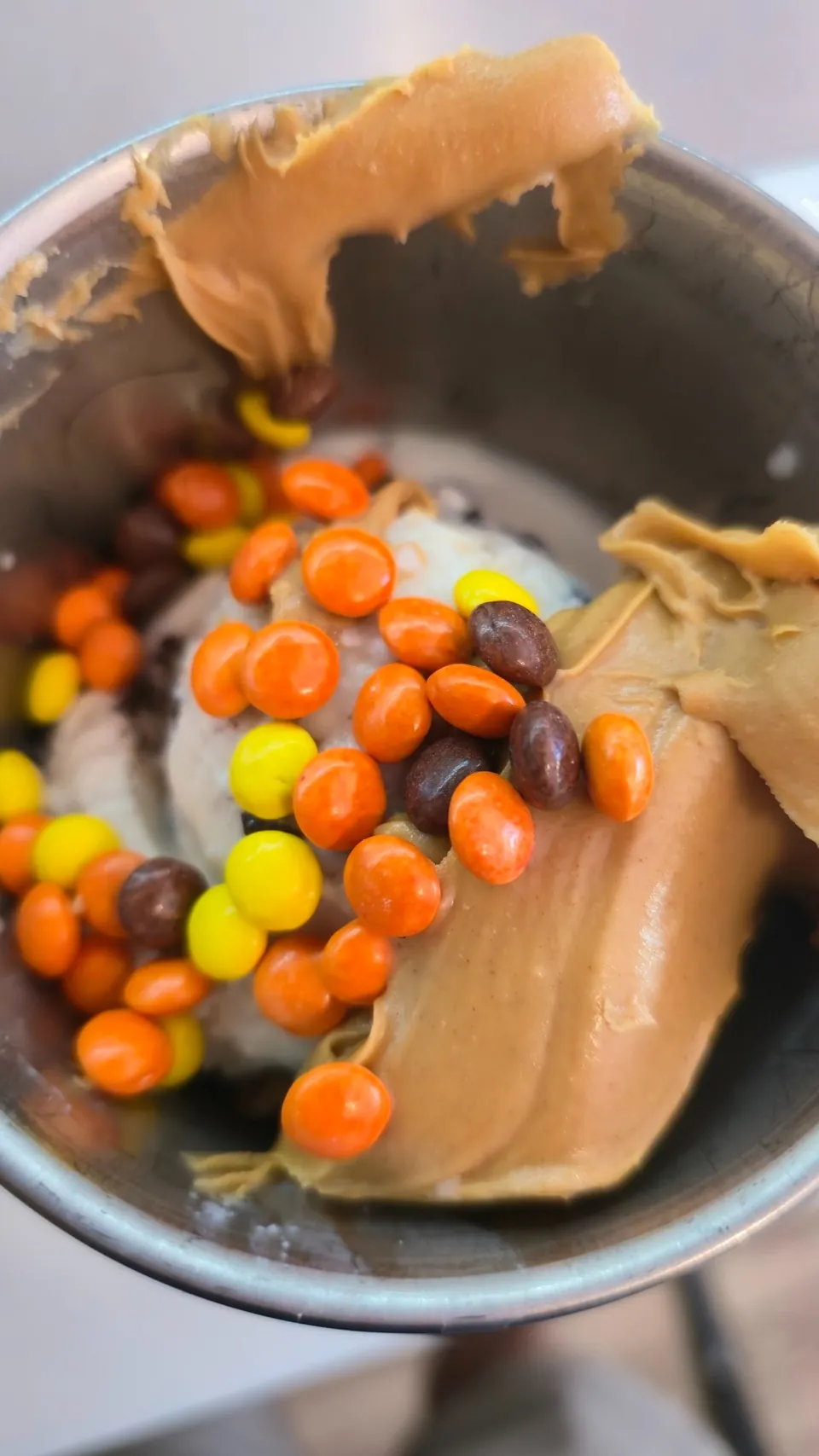 Peanut butter Avalanche being built — ice cream, Reese's Pieces, and peanut butter fold-in