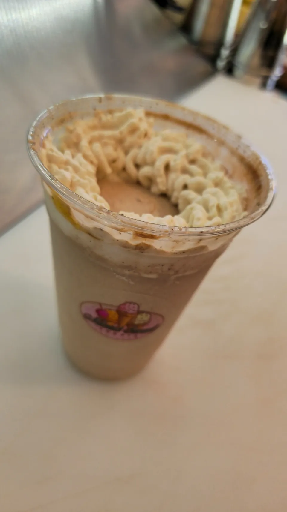 Chocolate milkshake with homemade whipped cream in a branded Mimi's cup